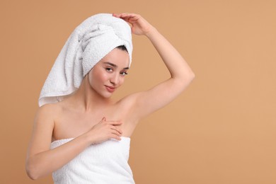 Photo of Beautiful woman showing armpit with smooth clean skin on beige background