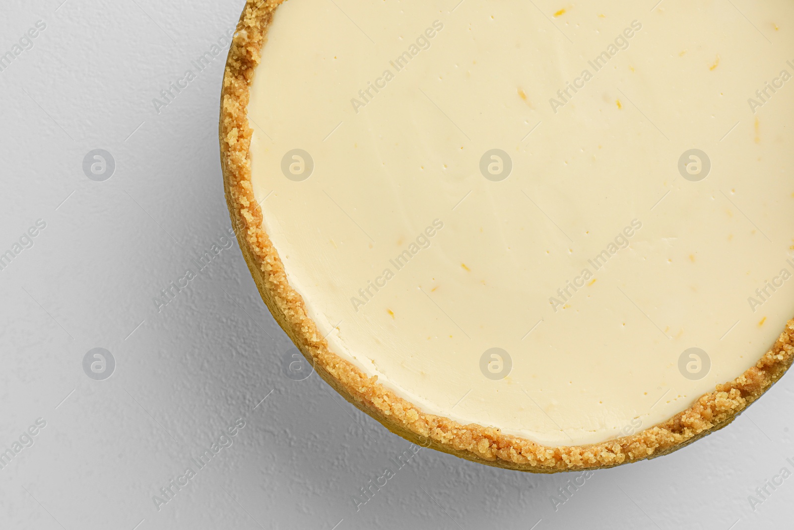 Photo of Tasty vegan tofu cheesecake on white table, top view. Space for text