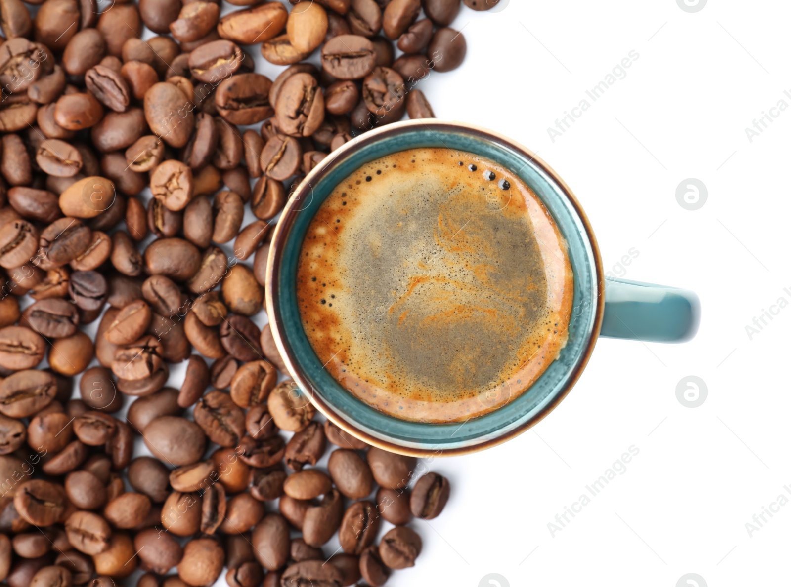 Photo of Cup of aromatic hot coffee and beans on white background, top view