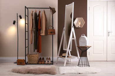 Modern dressing room interior with clothing rack and mirror