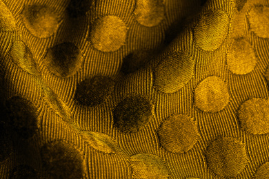 Textured golden fabric as background, closeup view