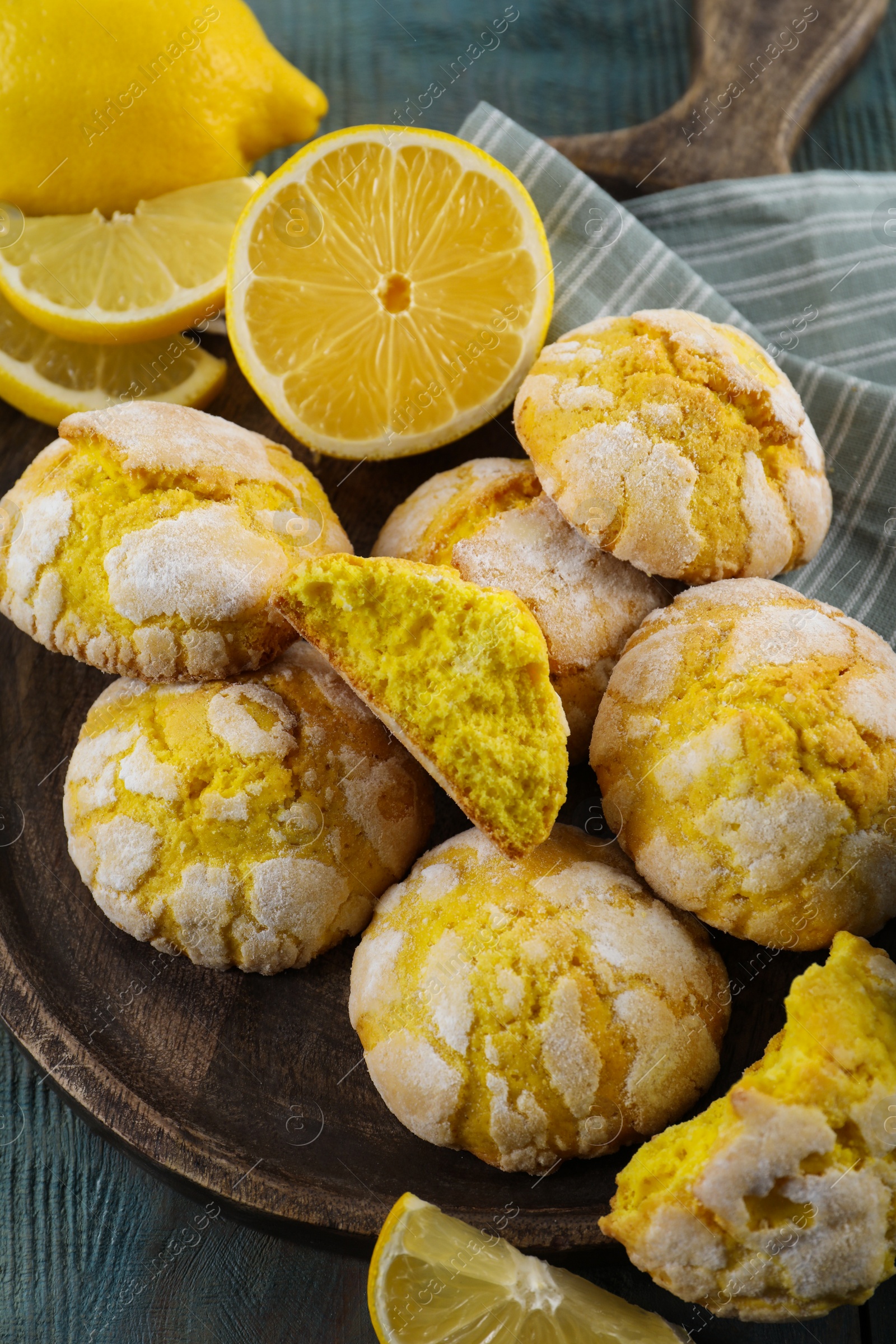 Photo of Delicious lemon cookies on wooden table, above view