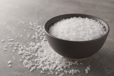 Photo of Bowl of natural sea salt on grey table