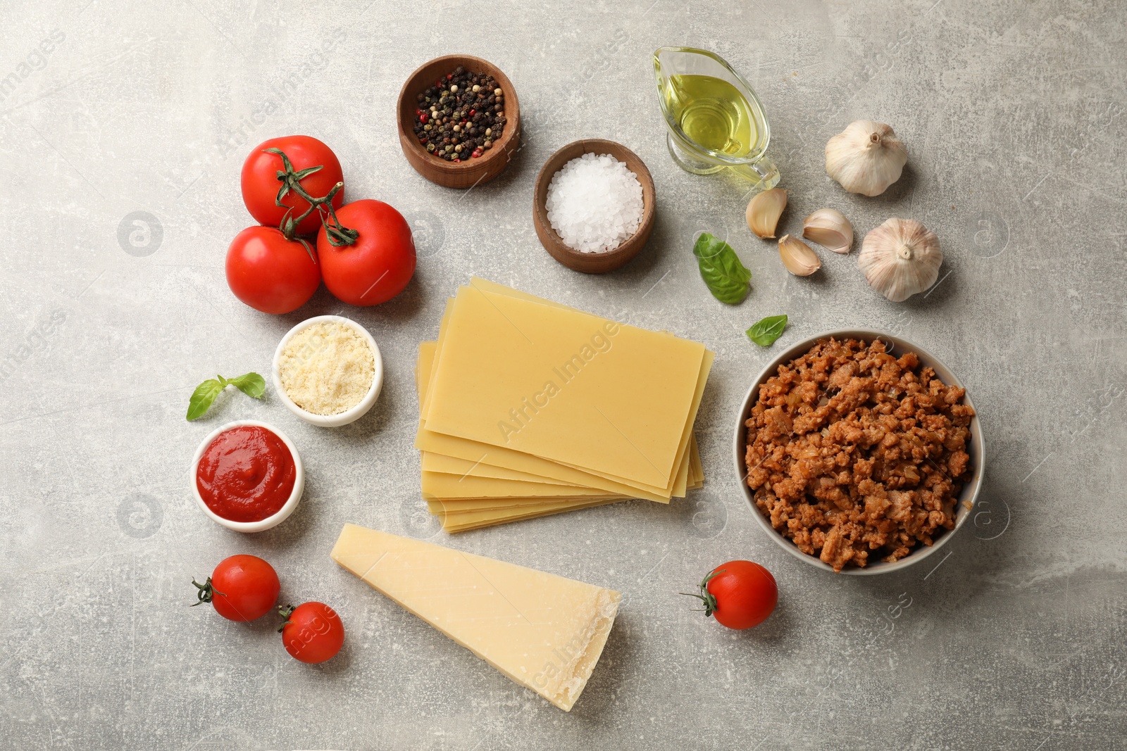 Photo of Flat lay composition with products for cooking lasagna on grey textured table