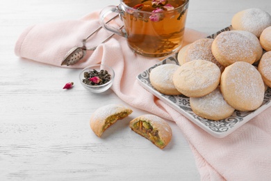 Traditional cookies for Islamic holidays and tea on wooden table. Eid Mubarak