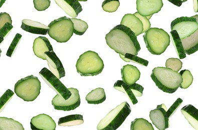 Image of Slices of fresh green cucumbers falling on white background