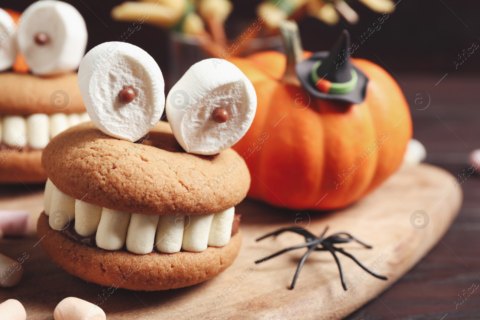 Photo of Delicious Halloween themed dessert on wooden table, closeup