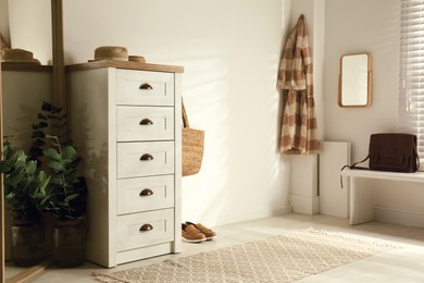 Photo of Chest of drawers in stylish room interior