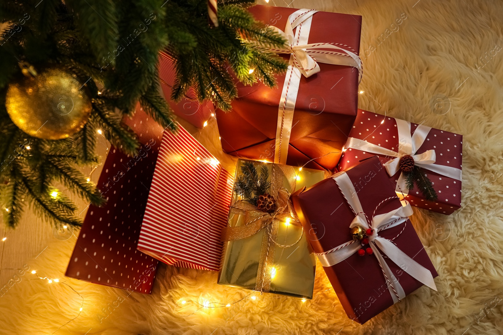 Photo of Many different gifts under Christmas tree, above view