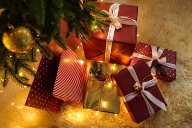 Many different gifts under Christmas tree, above view