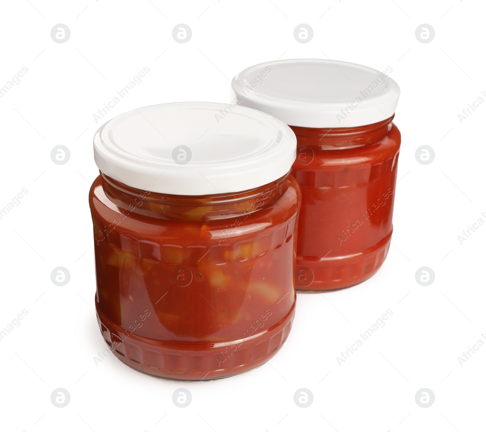 Photo of Glass jars of delicious canned lecho on white background