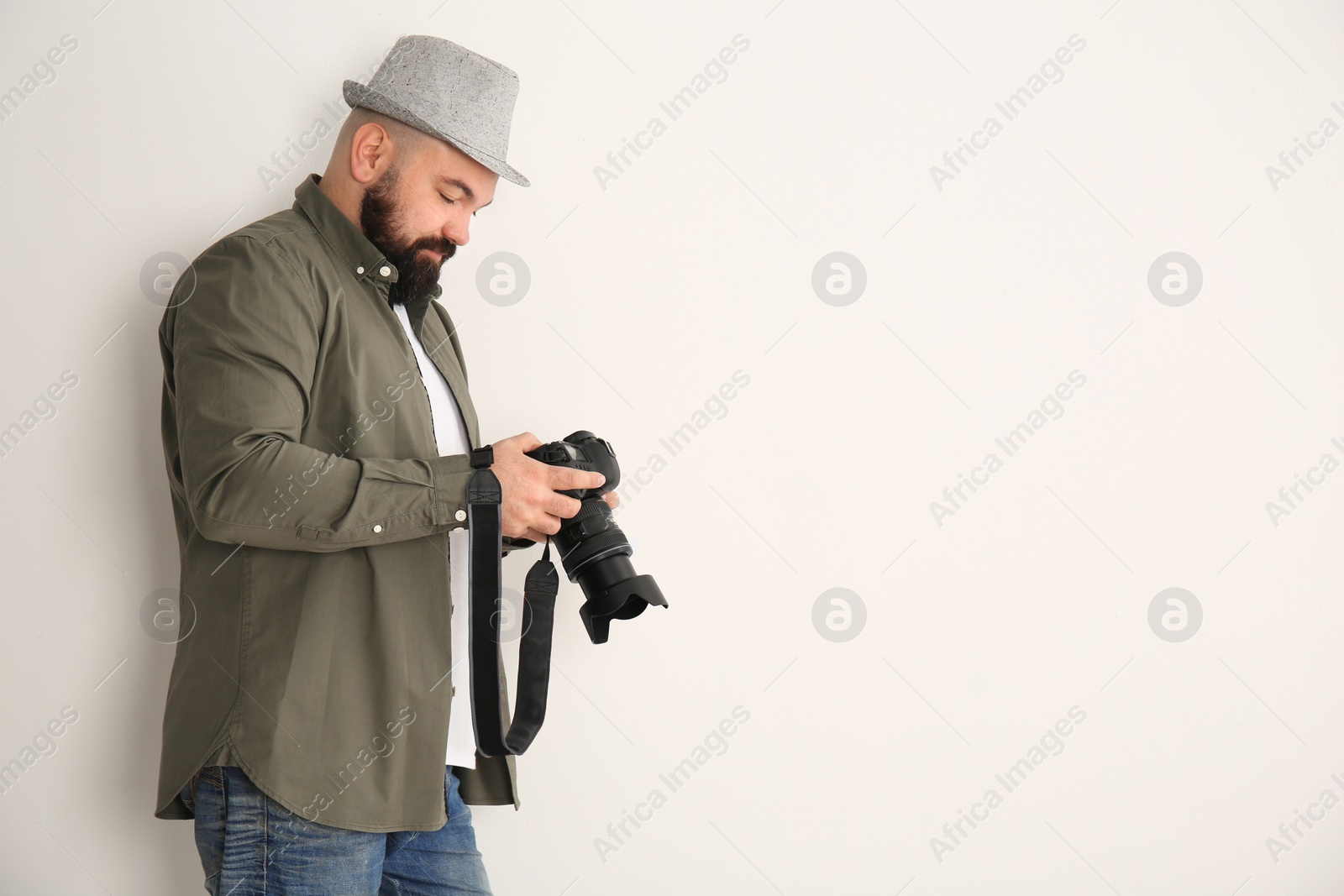 Photo of Male photographer with camera on white background