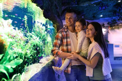Image of Happy family near aquarium in oceanarium. Spending time together