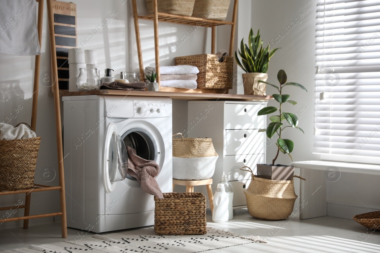 Photo of Stylish bathroom interior with modern washing machine