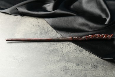 Photo of Magic wand and dark cloth on light grey table
