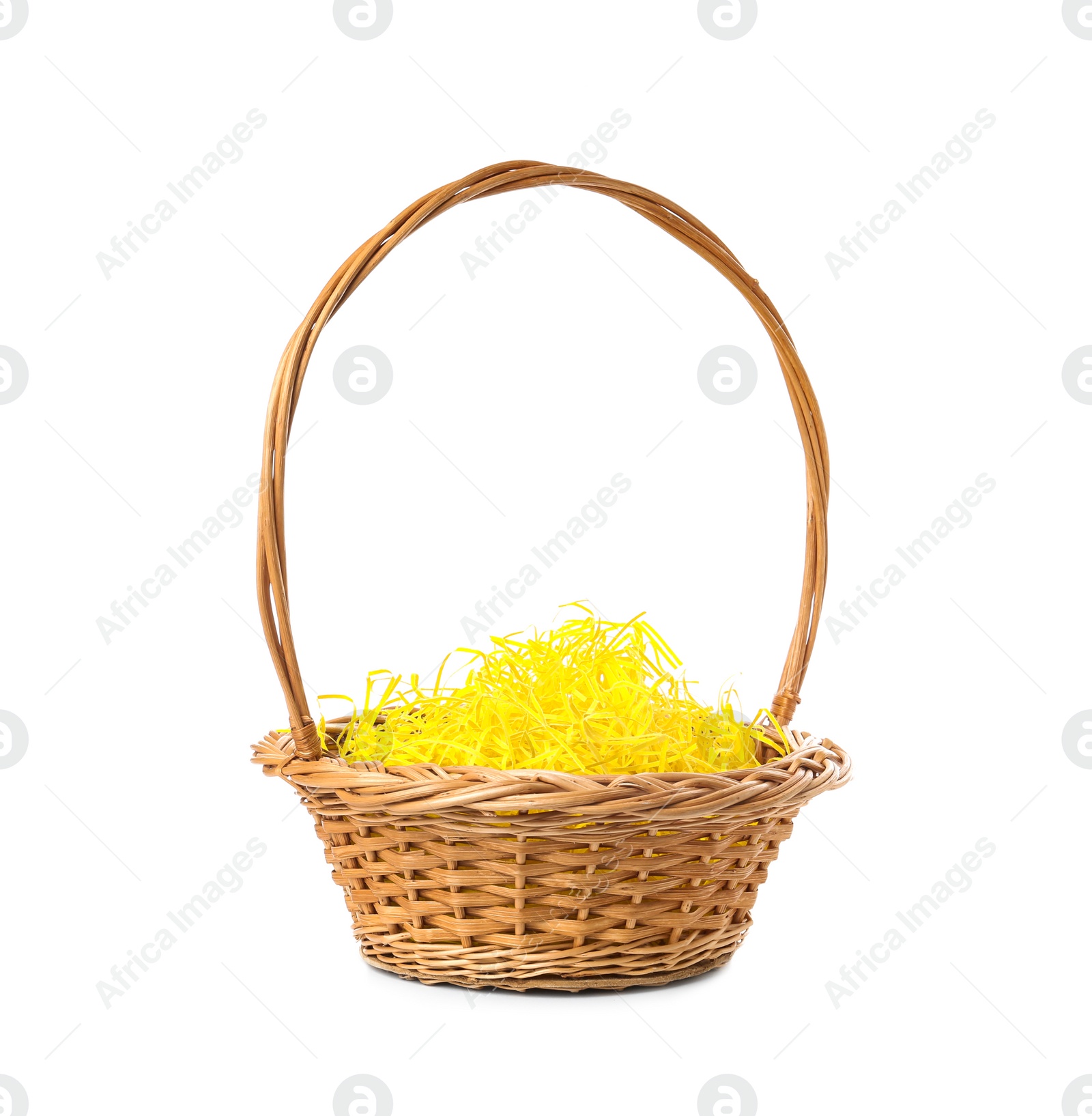 Photo of Wicker basket with yellow filler isolated on white. Easter item