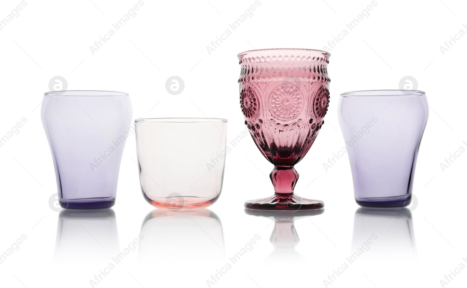 Photo of Set of colorful empty glasses on white background