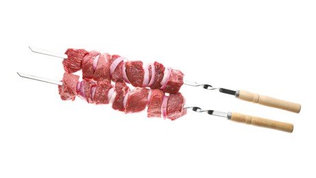 Metal skewers with raw meat and onion on white background