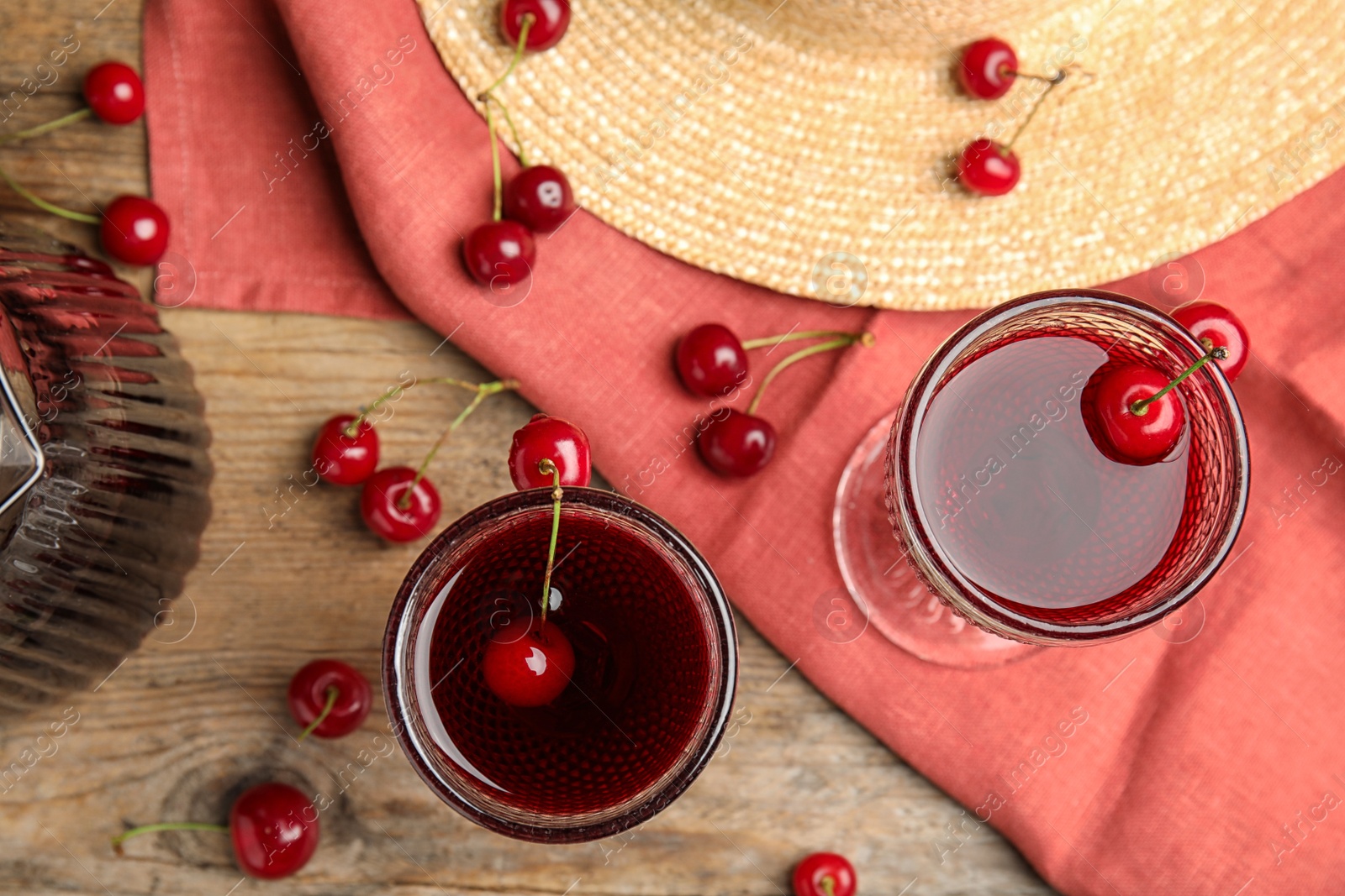 Photo of Delicious cherry wine with ripe juicy berries on wooden table, flat lay