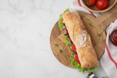 Photo of Delicious sandwich with sausages, vegetables and ingredients on white table, flat lay. Space for text