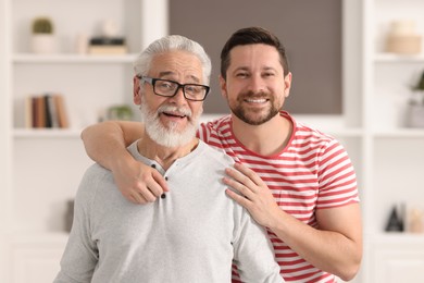 Happy son and his dad at home