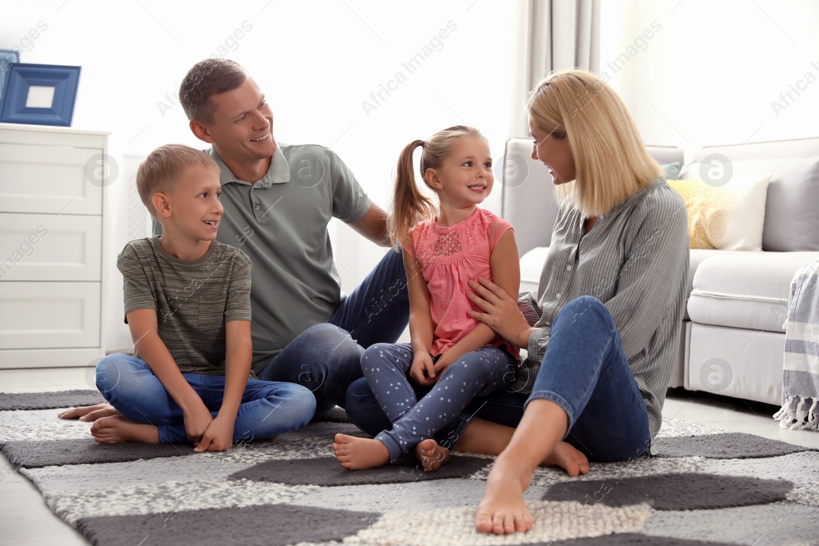 Photo of Happy family with children on floor at home