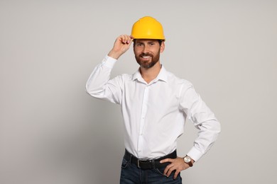 Photo of Professional engineer in hard hat on white background