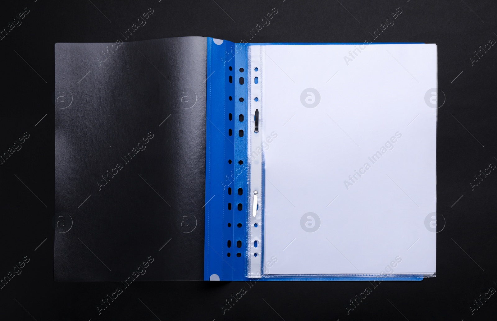 Photo of File folder with punched pockets and paper sheets on black background, top view