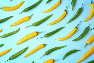 Flat lay composition with chili peppers on color background