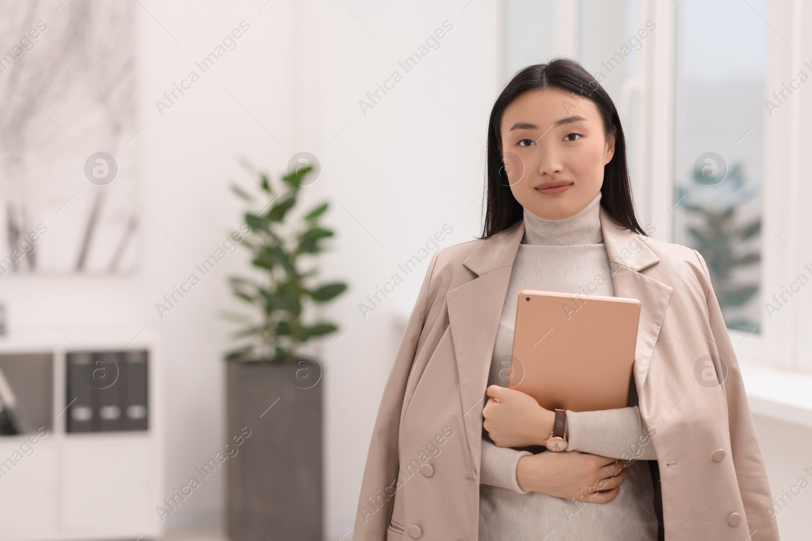 Photo of Portrait of beautiful businesswoman with tablet in office. Space for text