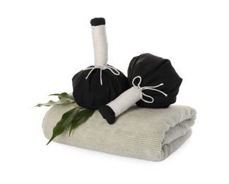 Photo of Spa composition with towel and herbal bags on white background