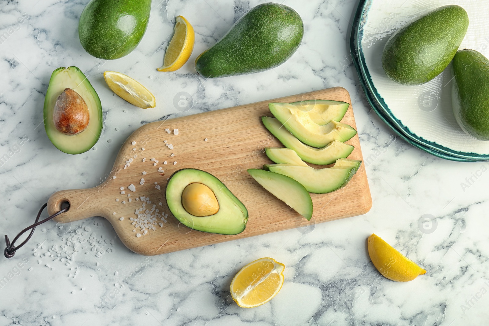 Photo of Flat lay composition with ripe avocados and lemon on marble background