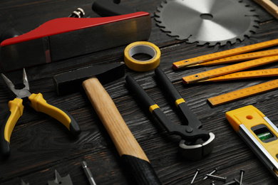 Photo of Different carpenter's tools on black wooden background