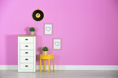 Photo of Stylish room interior with chest of drawers and space for text