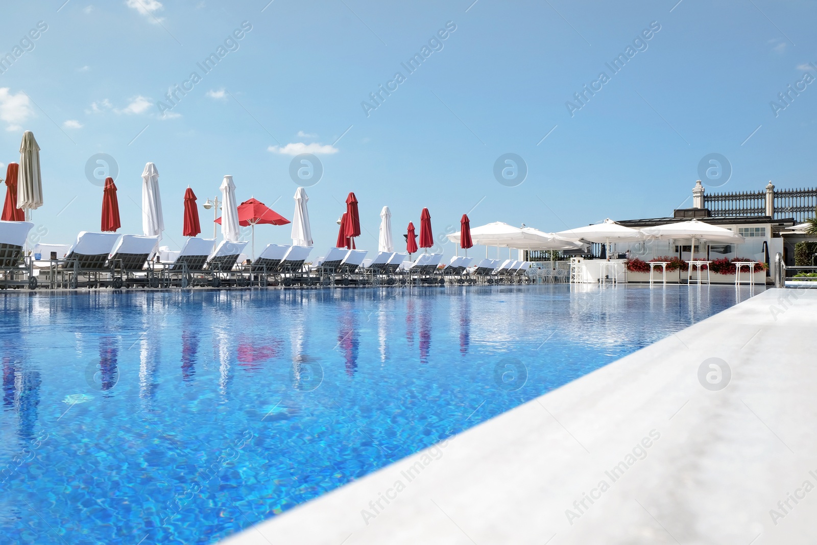 Photo of Outdoor swimming pool at sea resort on sunny day