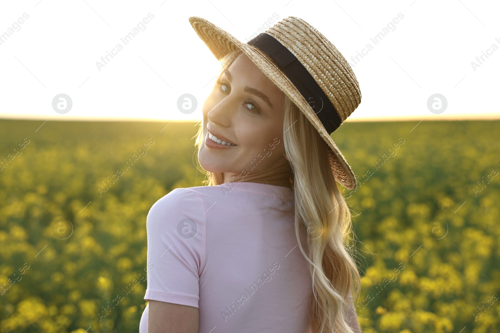 Photo of Portrait of happy young woman in field on spring day