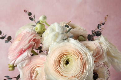 Photo of Beautiful delicate spring ranunculus flowers on color background, closeup