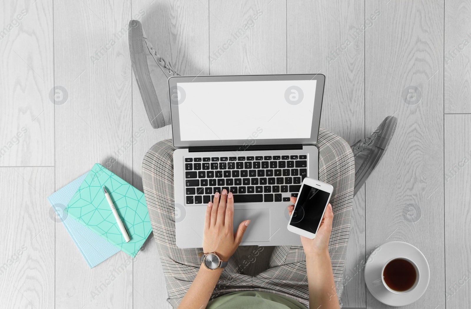 Photo of Top view of woman with laptop sitting on floor, closeup. Mockup for design