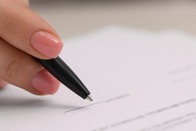 Woman signing document, closeup view. Space for text