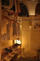 Modern dressing room with different stylish clothes and accessories