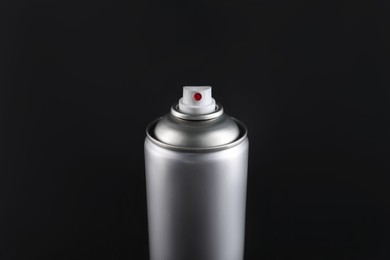 Photo of Can of spray paint on black background, closeup