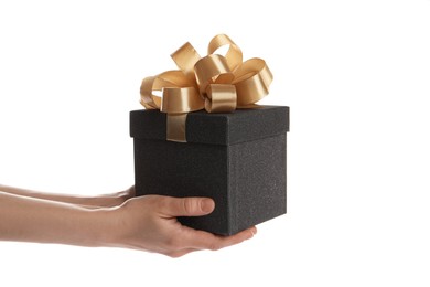 Woman holding black gift box on white background, closeup