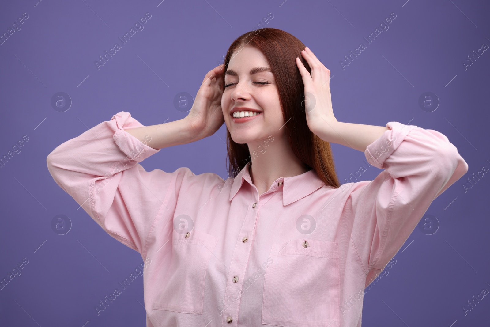 Photo of Portrait of smiling woman with freckles on purple background