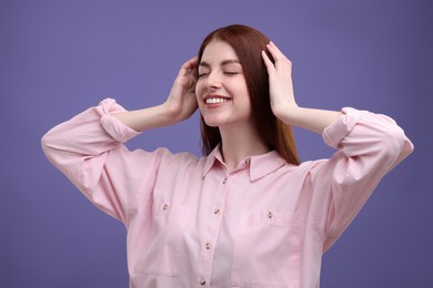 Portrait of smiling woman with freckles on purple background