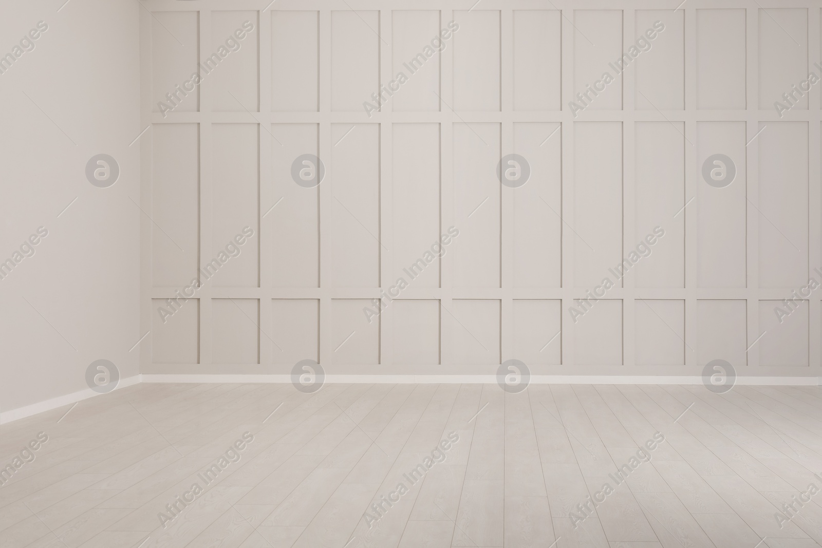 Photo of Empty room with beige walls and laminated flooring