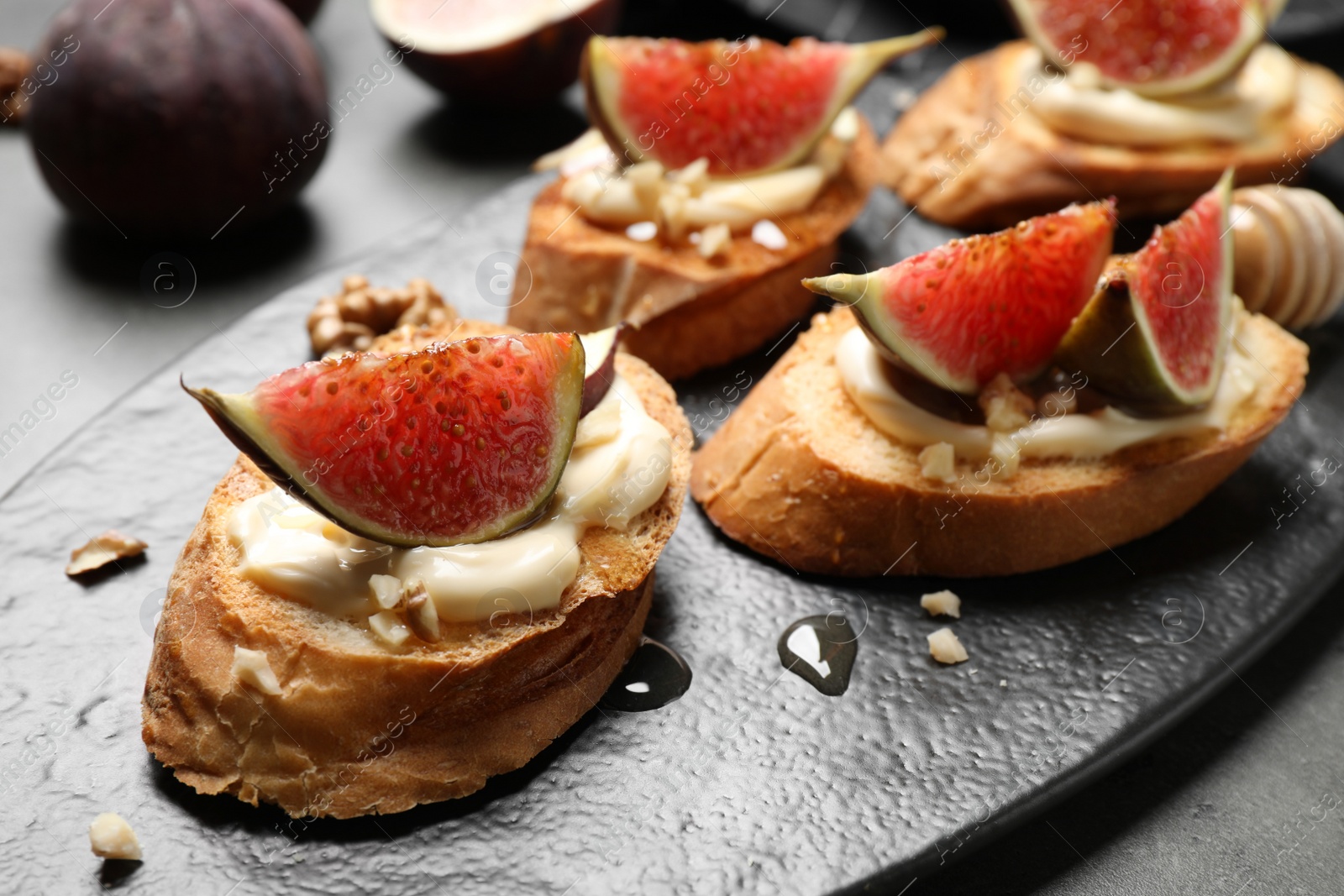 Photo of Bruschettas with ripe figs and cream cheese served on table