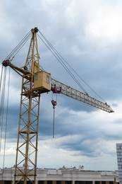 Photo of Construction site with tower crane under beautiful cloudy sky