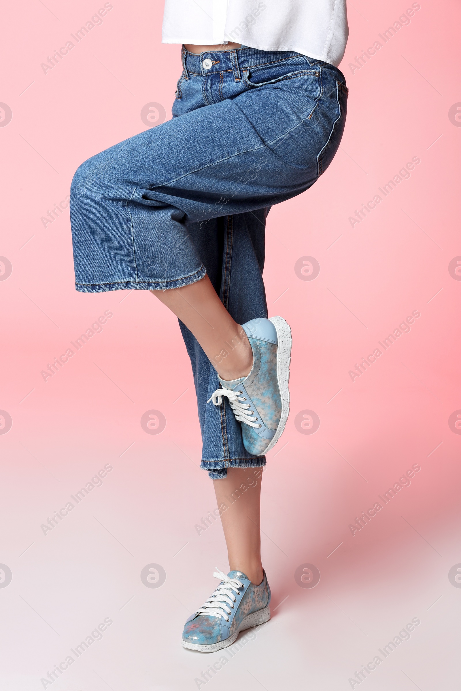 Photo of Woman in stylish shoes on color background, closeup