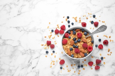 Photo of Healthy homemade granola with berries and almonds on white marble table, top view. Space for text