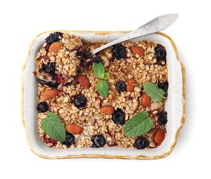 Photo of Tasty baked oatmeal with berries and almonds in baking tray isolated on white, top view